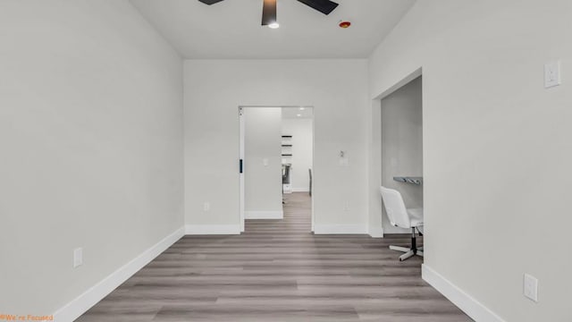 empty room featuring ceiling fan and light hardwood / wood-style floors