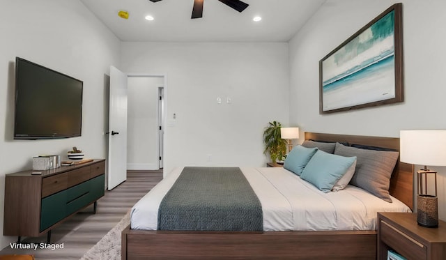 bedroom with ceiling fan and dark hardwood / wood-style floors