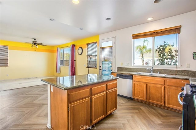 kitchen featuring dishwasher, a kitchen island, light parquet flooring, sink, and black electric range oven