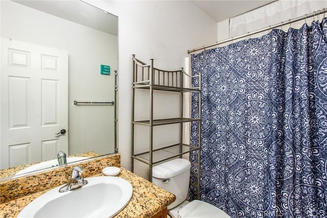 bathroom featuring toilet and vanity