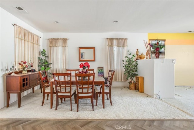 dining room featuring parquet floors