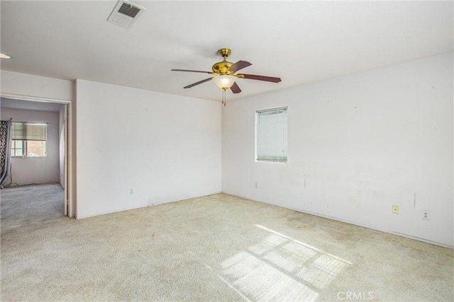 carpeted spare room with ceiling fan