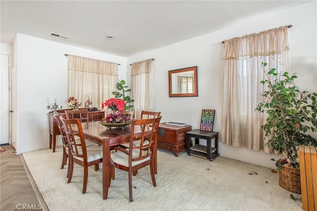 dining space with parquet floors