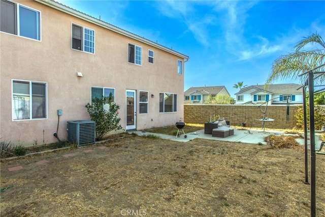 rear view of property with central AC and a patio