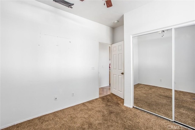 unfurnished bedroom with ceiling fan, a closet, and carpet floors