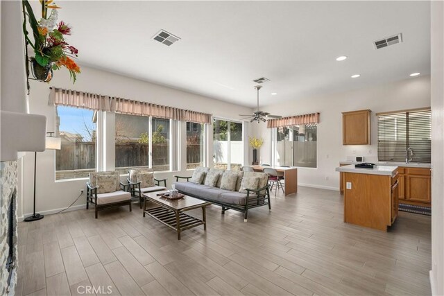 living room featuring light wood-type flooring and ceiling fan