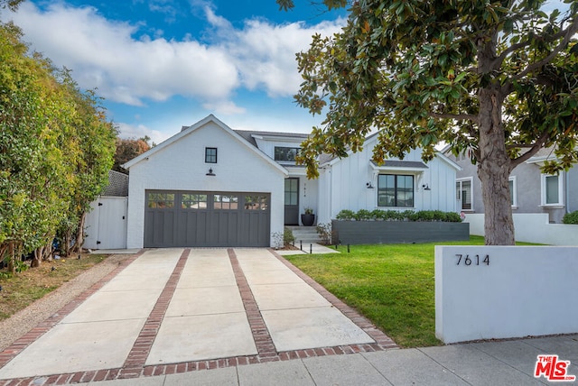 modern inspired farmhouse featuring a front yard and a garage