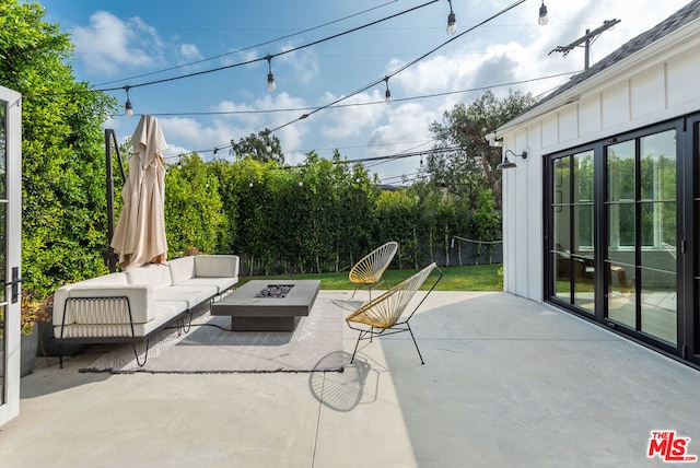 view of patio / terrace featuring an outdoor living space with a fire pit