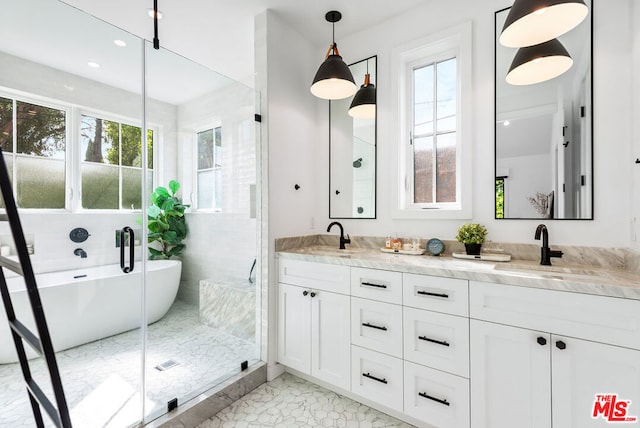 bathroom featuring tile patterned flooring, a tub to relax in, and vanity