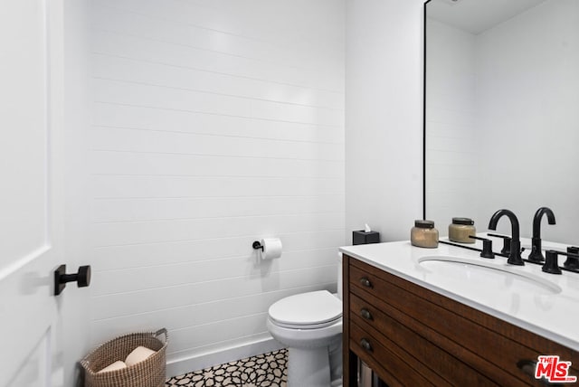 bathroom featuring toilet and vanity