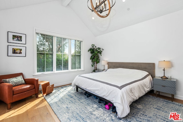 bedroom featuring hardwood / wood-style floors, a chandelier, and vaulted ceiling with beams