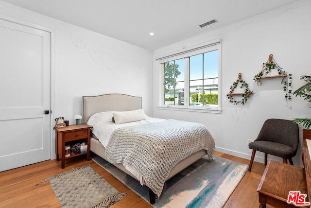 bedroom with hardwood / wood-style floors