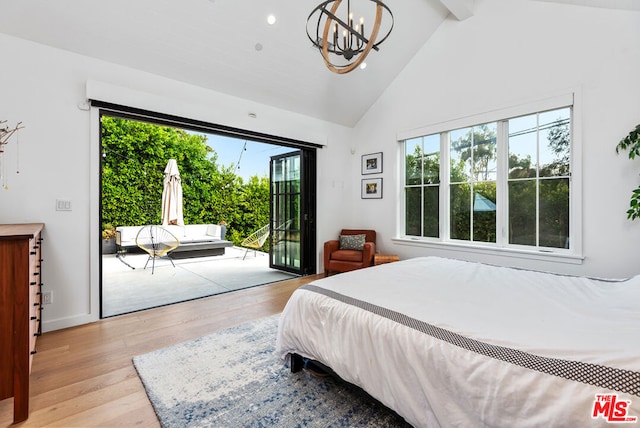 bedroom with light wood-type flooring, access to exterior, beamed ceiling, and multiple windows