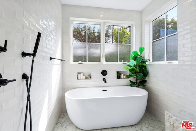 bathroom with a tub to relax in