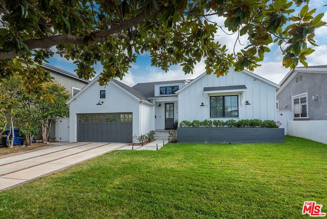 modern farmhouse with a front yard and a garage