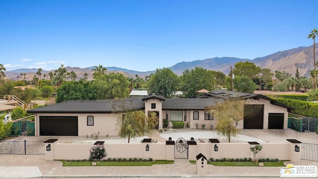 view of front of property with a mountain view and a garage