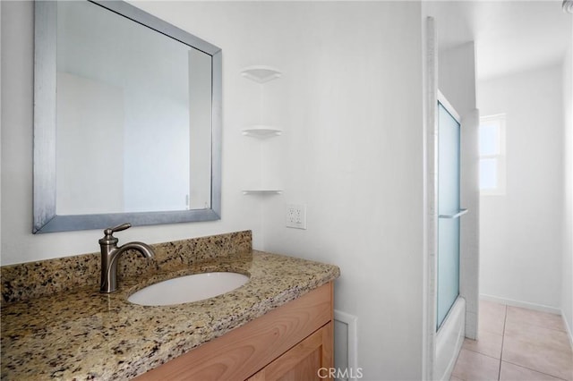 bathroom featuring tile patterned floors, vanity, and shower / bath combination with glass door