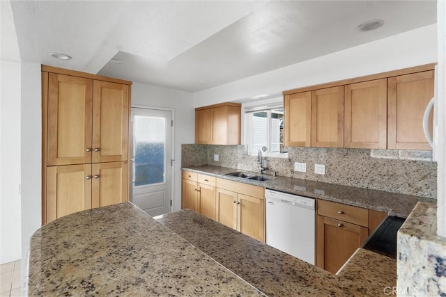 kitchen with backsplash, dishwasher, and sink