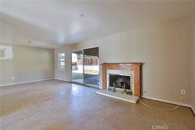 unfurnished living room featuring a tiled fireplace