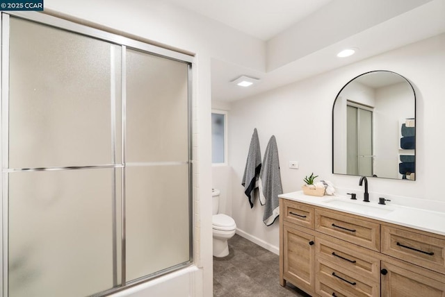 full bathroom featuring toilet, vanity, and combined bath / shower with glass door