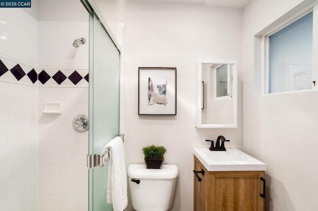 bathroom with toilet, walk in shower, and vanity