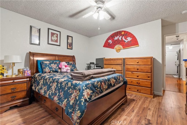 bedroom featuring ceiling fan, a textured ceiling, and hardwood / wood-style floors