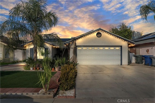 view of front of property featuring solar panels and a garage