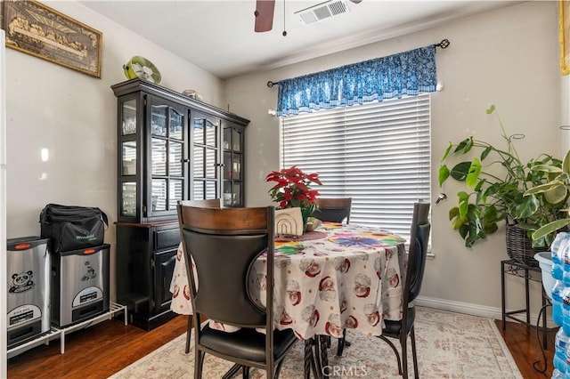 dining space with ceiling fan and dark hardwood / wood-style floors