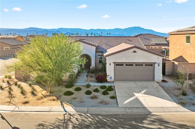 view of front of property featuring a mountain view and a garage