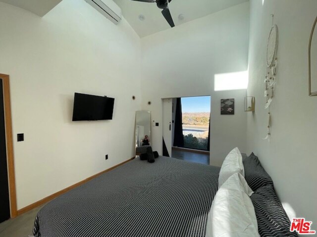 living room with ceiling fan, an AC wall unit, a high ceiling, wood ceiling, and french doors