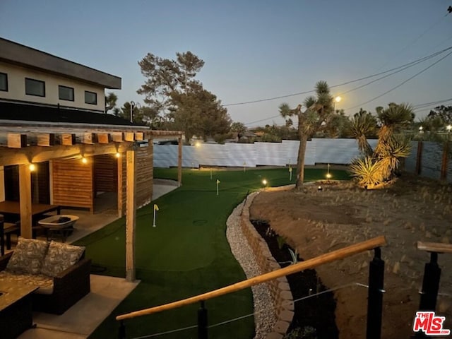 yard at dusk with a pergola, a patio area, and an outdoor fire pit