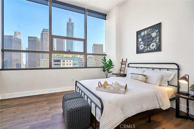 bedroom featuring multiple windows and hardwood / wood-style floors