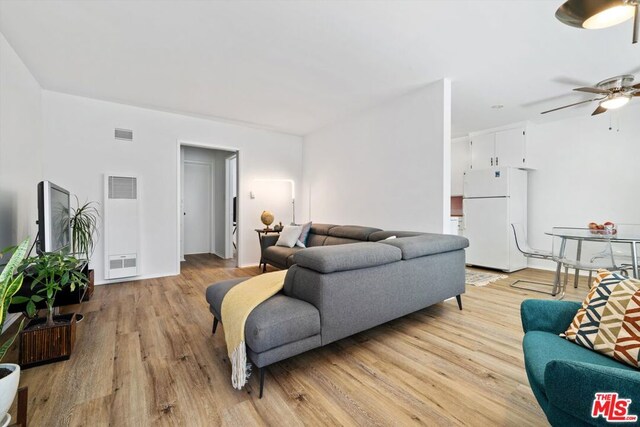 living room featuring ceiling fan and light hardwood / wood-style flooring