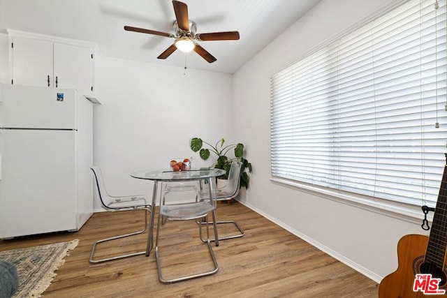 dining room with light wood-type flooring and ceiling fan