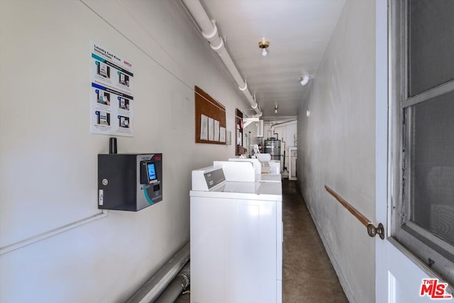 washroom featuring washing machine and dryer and water heater