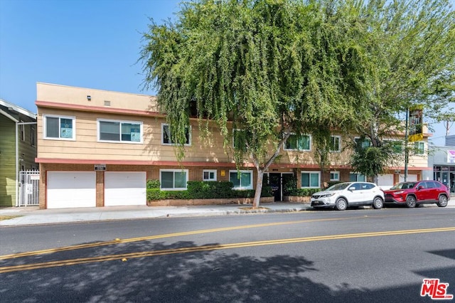 multi unit property featuring a garage