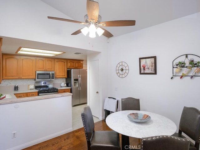 dining area featuring hardwood / wood-style flooring and lofted ceiling