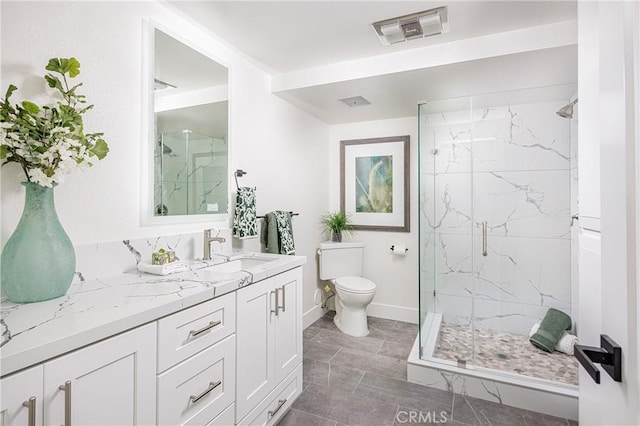 bathroom with toilet, a shower with shower door, and vanity