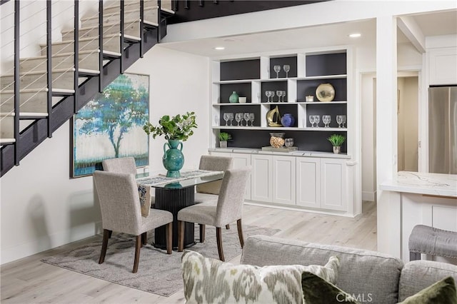 dining space featuring light hardwood / wood-style floors and built in features