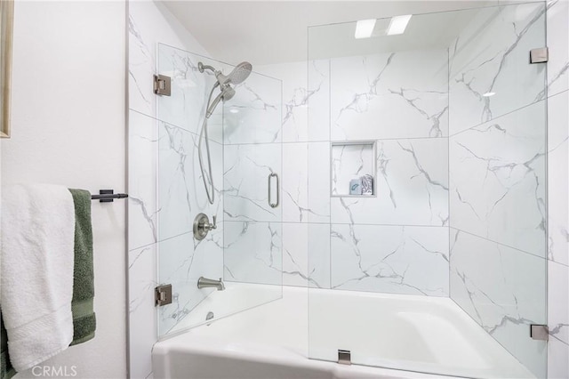 bathroom featuring combined bath / shower with glass door