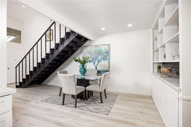 dining space with light hardwood / wood-style flooring