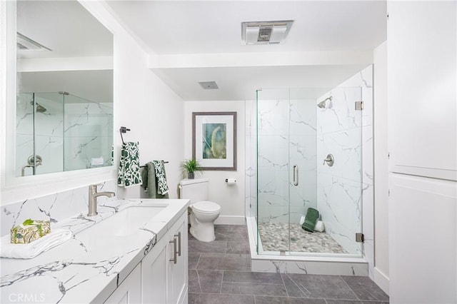 bathroom featuring an enclosed shower, vanity, and toilet