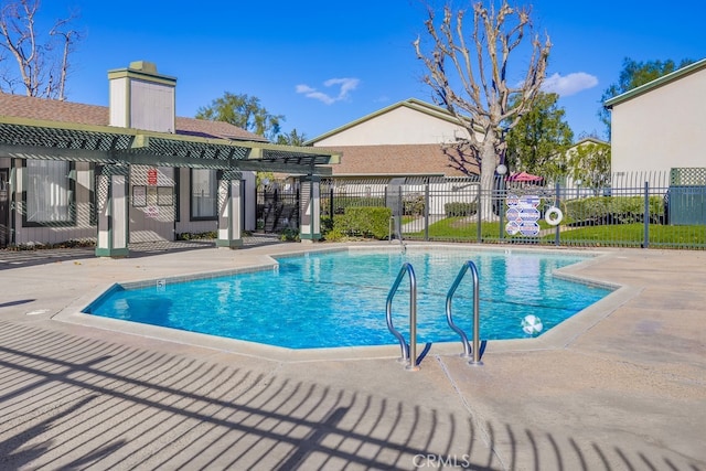 view of swimming pool with a patio area and a pergola