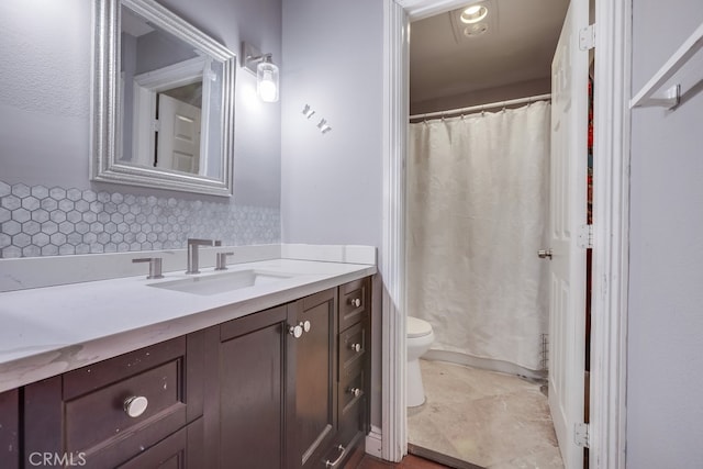 bathroom with tasteful backsplash, vanity, curtained shower, and toilet