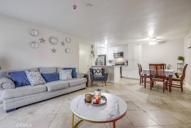 tiled living room with ceiling fan