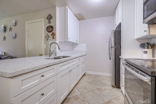 kitchen featuring light tile patterned flooring, sink, white cabinetry, appliances with stainless steel finishes, and kitchen peninsula