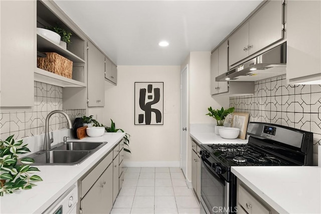 kitchen featuring sink, light tile patterned floors, stainless steel gas range, and tasteful backsplash