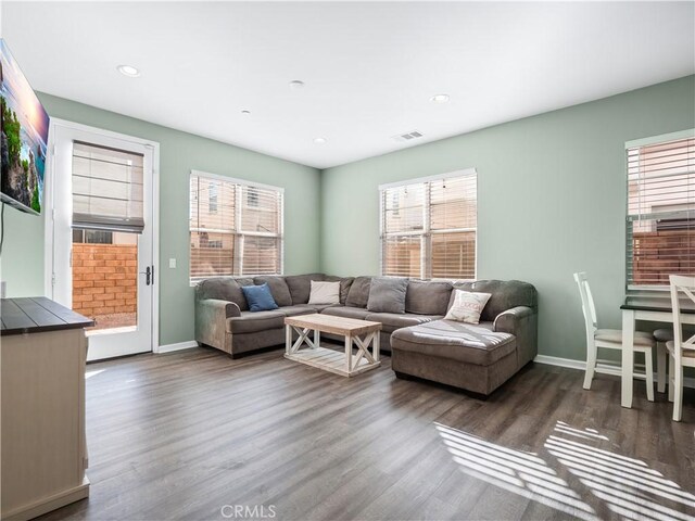 living room with a healthy amount of sunlight and dark hardwood / wood-style floors