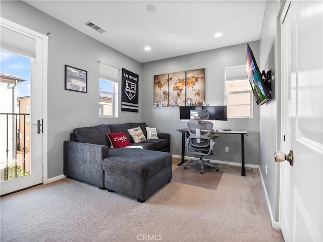 home office featuring a wealth of natural light and carpet