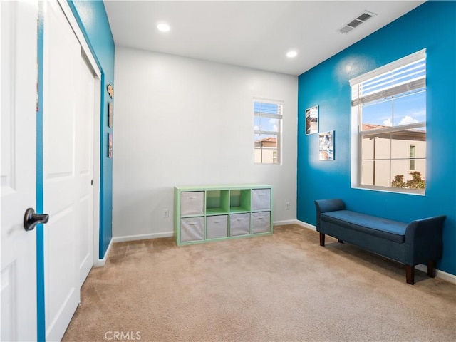 sitting room with light colored carpet